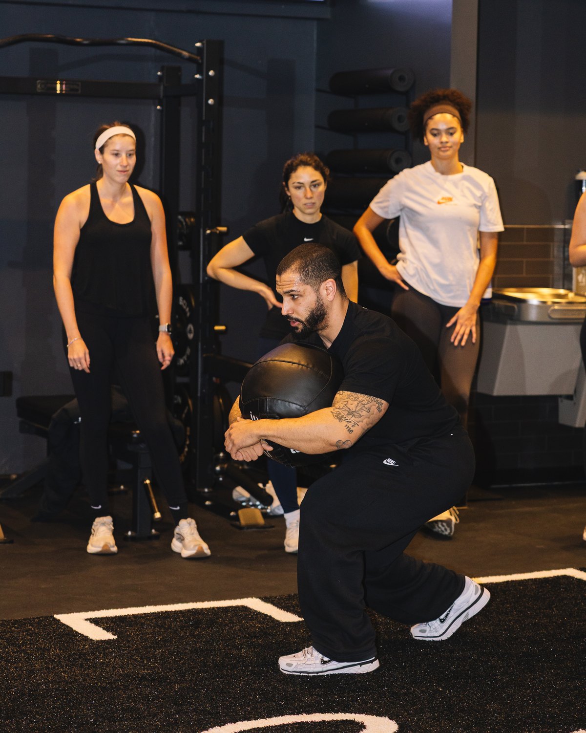 A coached Arena Training class mid session on the GUDSPORT floor.