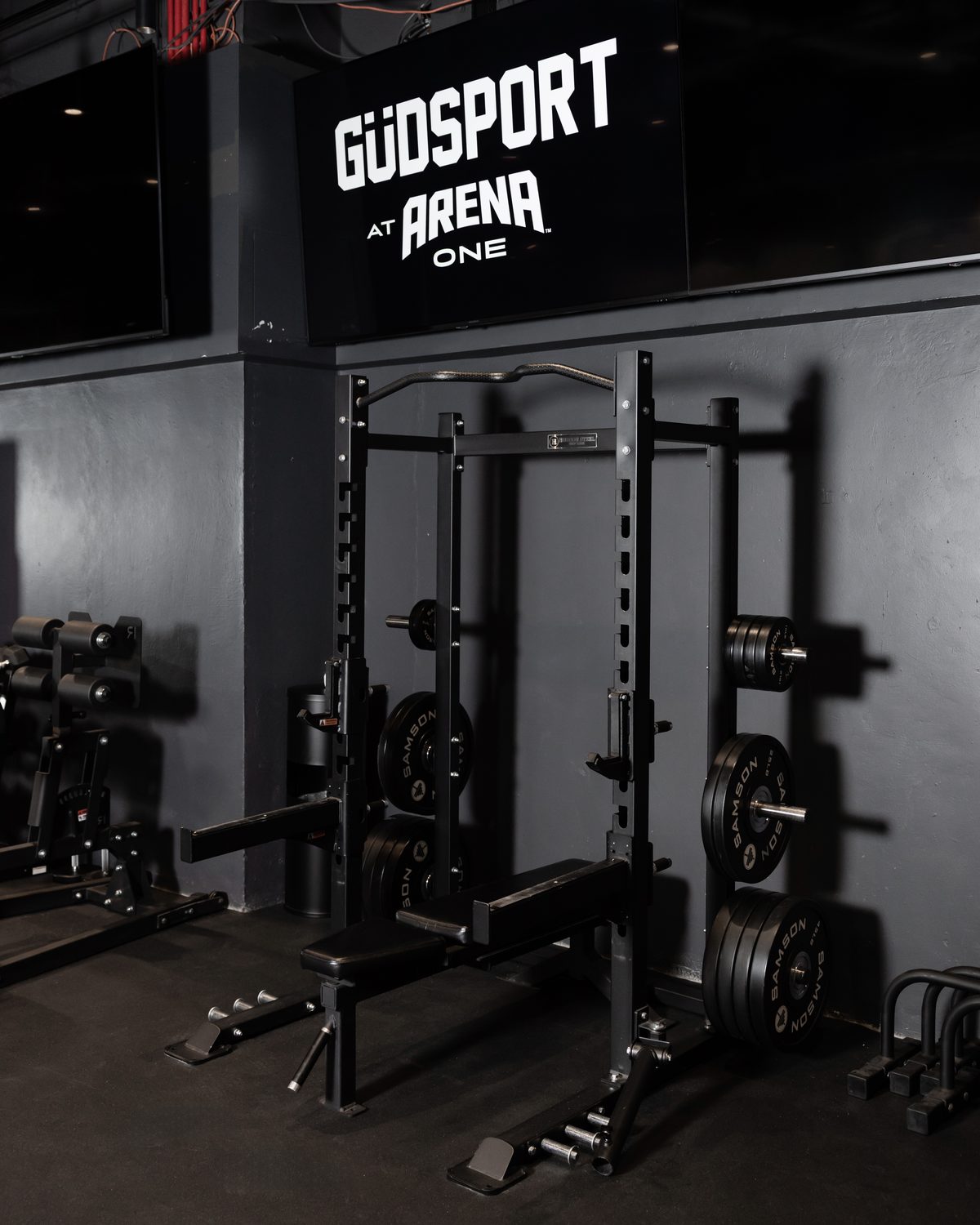 The GÜDSPORT training floor and rig beneath the GÜDSPORT at ARENA ONE sign.